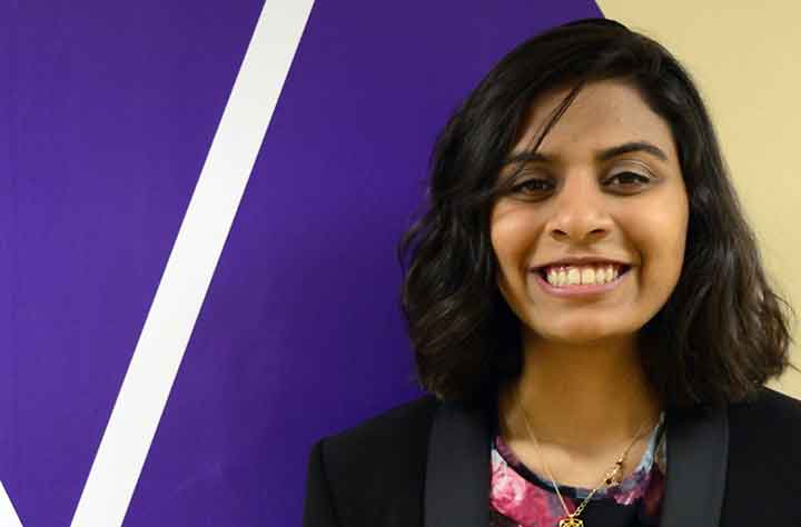 Current Wesleyan Student FATIMA KHAN smiles for the camera in the hallway of OSP