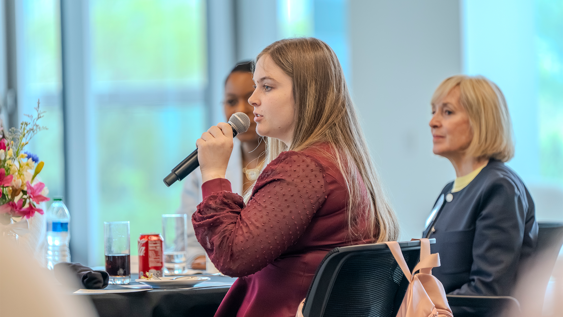 Student speaking into microphone at an event