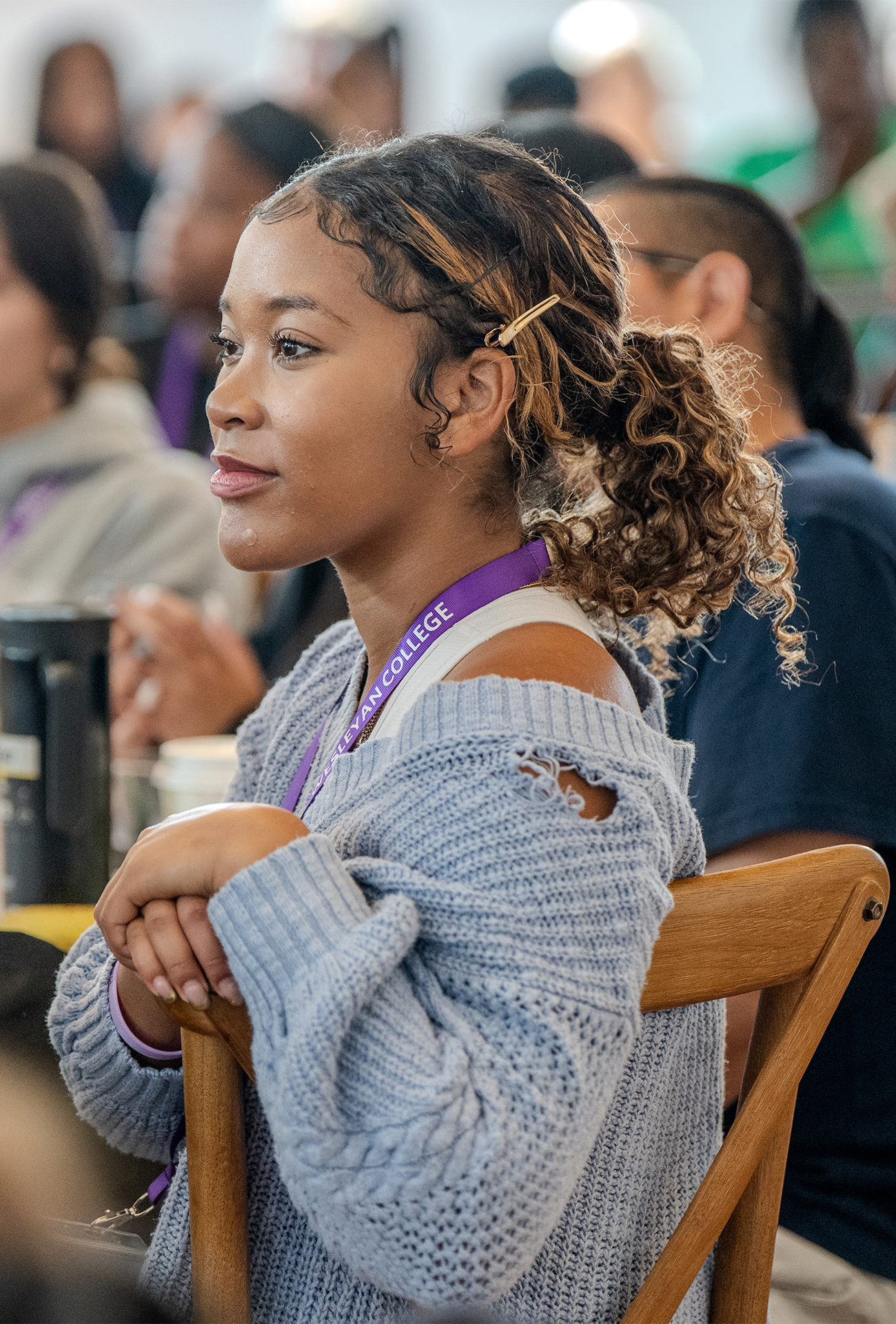 Student sitting at a table, engaged in listening